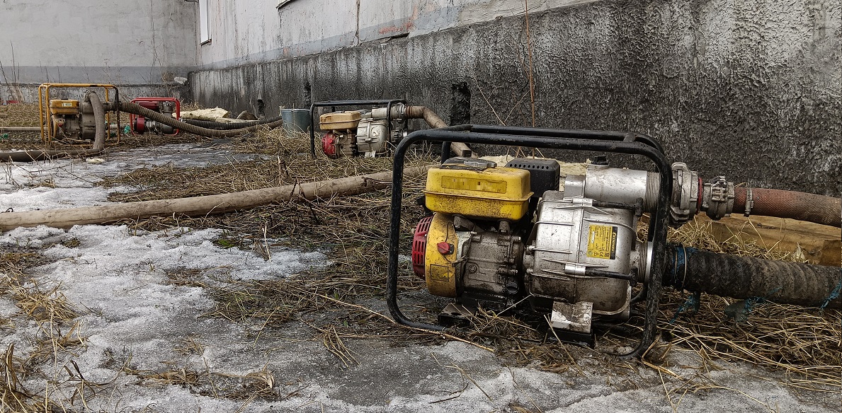 Откачка мотопомпами талой воды из подвала дома в Ненецком АО